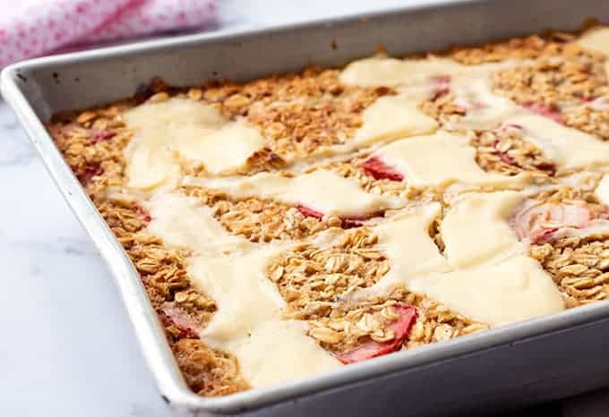 Baking dish full of strawberry baked oatmeal with a cream cheese swirl
