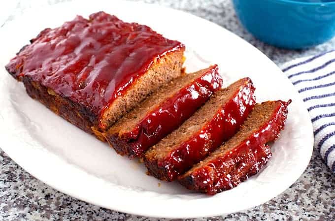 The Best Easy Meatloaf sliced on a white plate