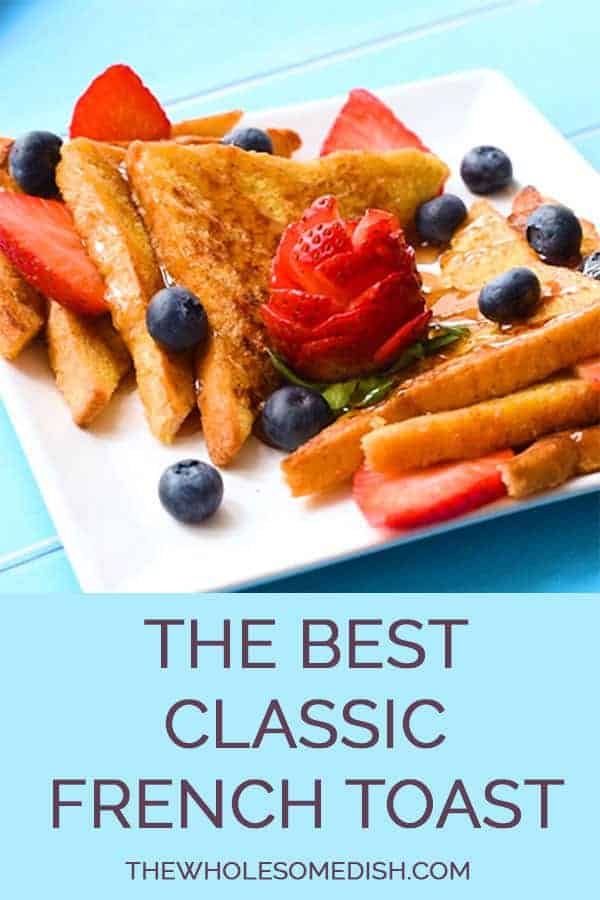 The Best Easy French Toast Recipe sliced on a plate with maple syrup, strawberries, and blueberries