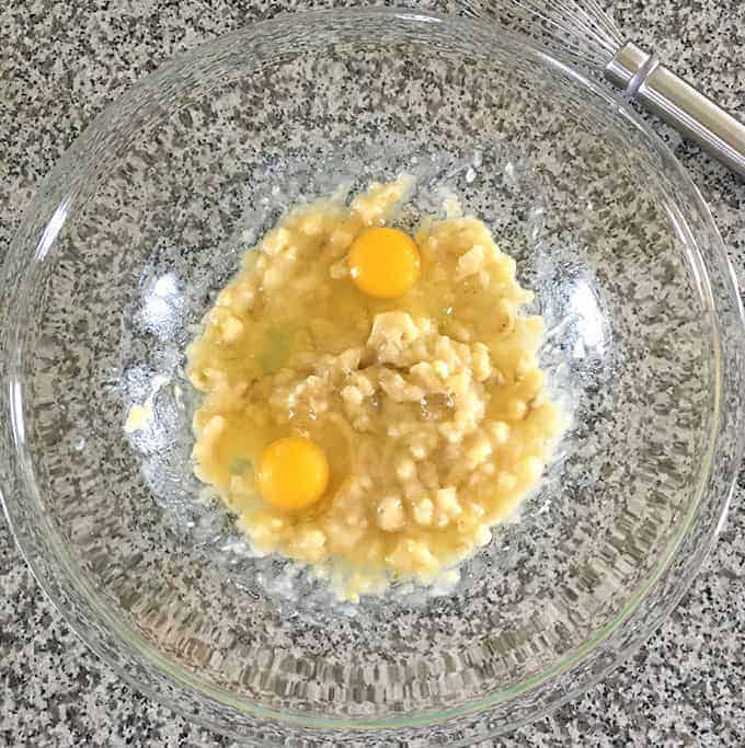 2 eggs and mashed bananas in a bowl for the best banana bread recipe