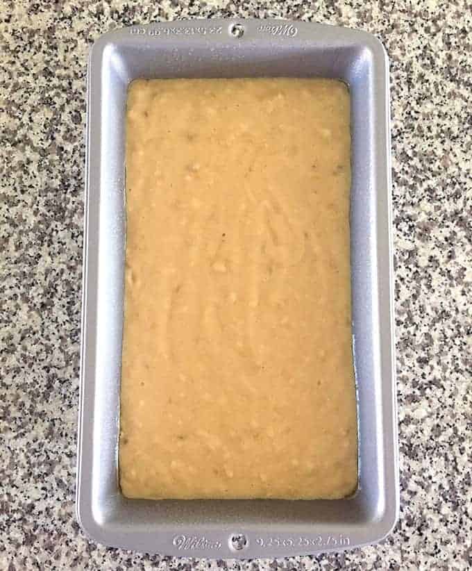 Loaf pan full of uncooked Buttermilk Banana Bread batter