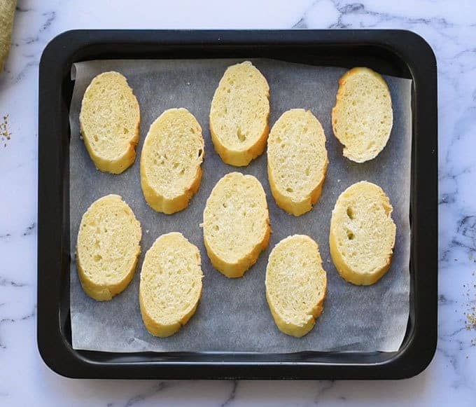 sliced baguette on a broiler plate