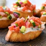Greek Bruschetta Recipe with toast, creamy feta spread, and Greek seasoned toppings