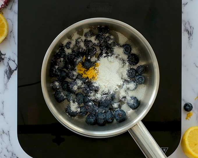 pot of fresh blueberries, sugar, lemon juice, lemon zest, corn starch, and salt for blueberry sauce