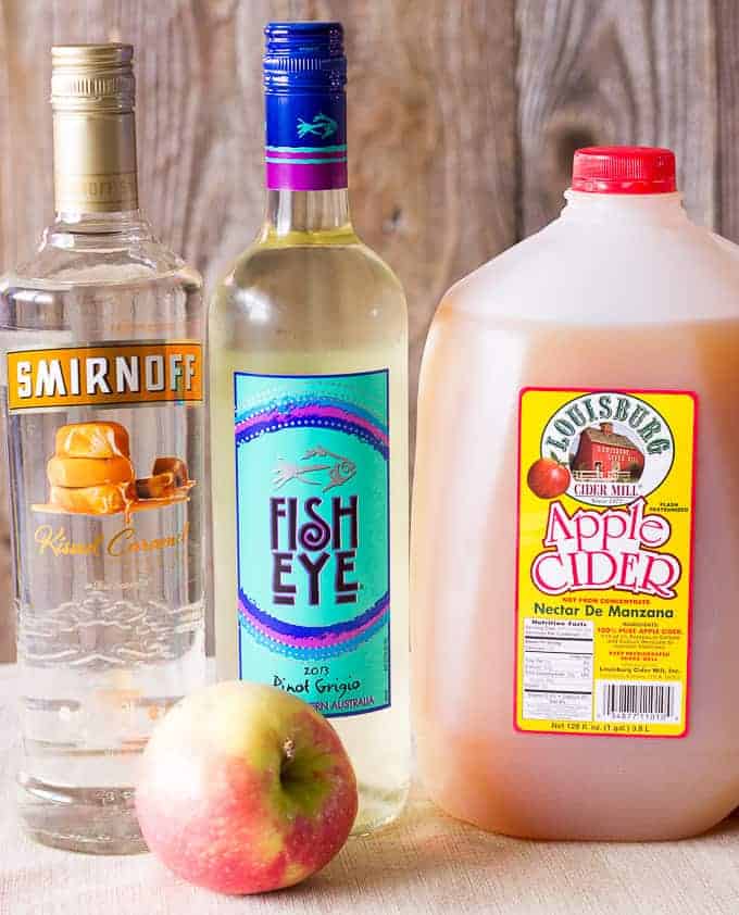 Ingredients for Caramel Apple Sangria: White wine, caramel vodka, apple cider, and apples