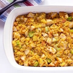 Large serving dish of corn bread stuffing with apples celery and onions