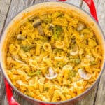 One pot pasta with broccoli and mushrooms in a red pot