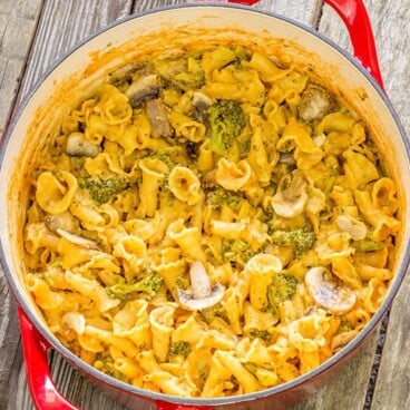 One pot pasta with broccoli and mushrooms in a red pot