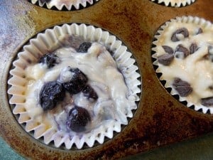 uncooked muffins with blueberries in a muffin tin