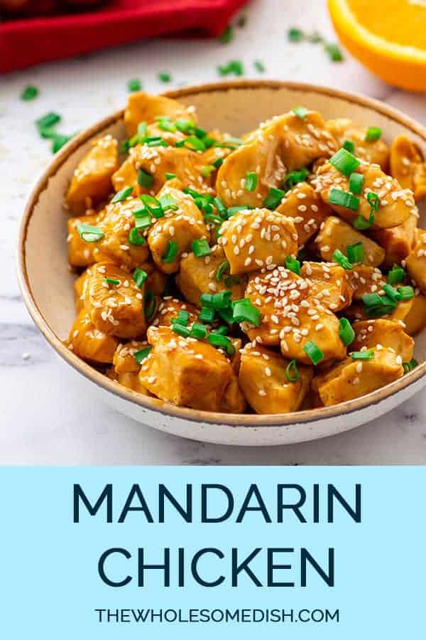 Mandarin Chicken Recipe in a bowl topped with sesame seeds and green onions