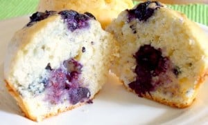 blueberry muffin cut in half on a white plate