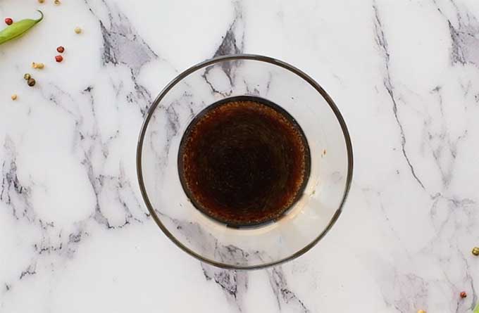 Soy sauce, olive oil, and sugar in a mixing bowl for Chinese green beans