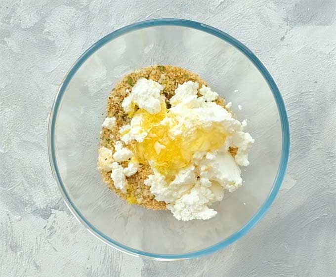 mixing bowl full of Italian seasoned breadcrumbs, ricotta cheese, honey, and lemon zest for stuffed eggplant