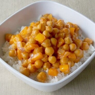 Coconut Curry Garbanzo Beans over white rice in a bowl