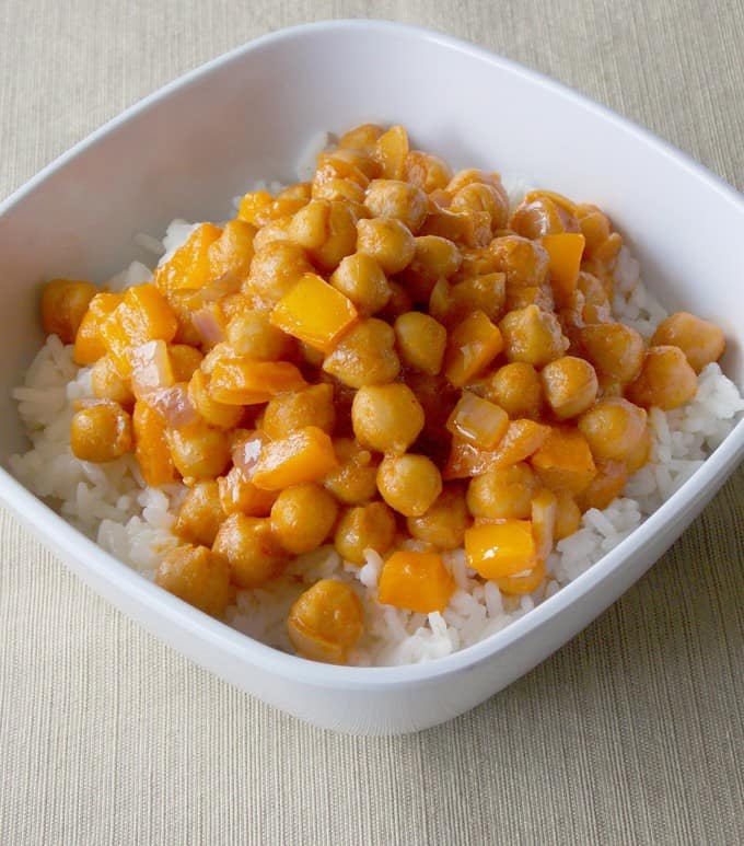 white bowl full of Coconut Curry Garbanzo Beans over white rice