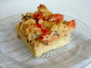 slice of tomato basil bread pudding on a plate