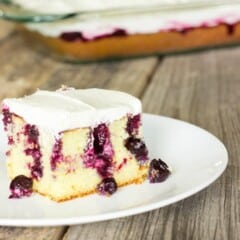 slice of Blueberry Lemon Poke Cake on a white plate