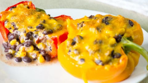 2 Chipotle Black Bean & Corn Stuffed Peppers on a white plate