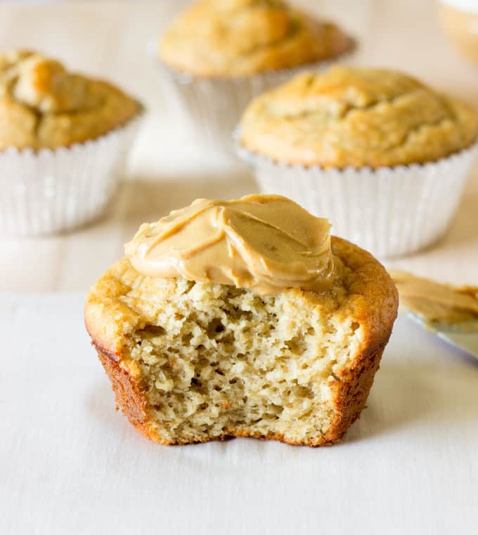 half of a Banana Peanut Butter Oat Muffin with peanut butter spread on top
