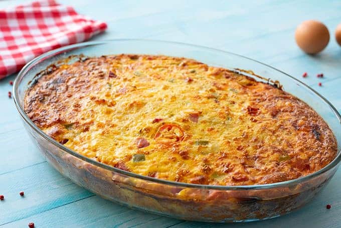 Baked cheesy hash brown breakfast casserole in a baking dish