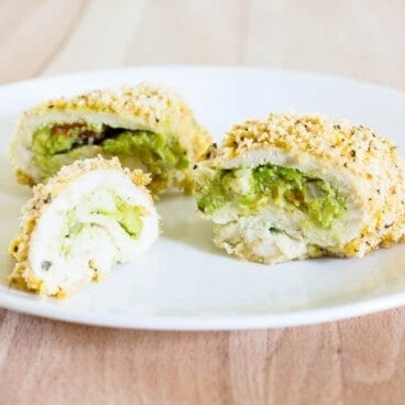 sliced Guacamole Stuffed Chicken Breasts on a white plate