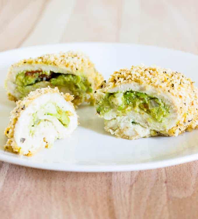 sliced Guacamole Stuffed Chicken Breasts on a white plate