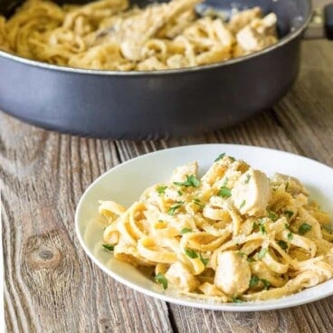 white bowl full of One Pot Cajun Chicken Alfredo