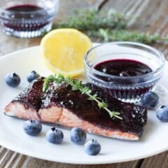 piece of blueberry balsamic glazed salmon on a white plate