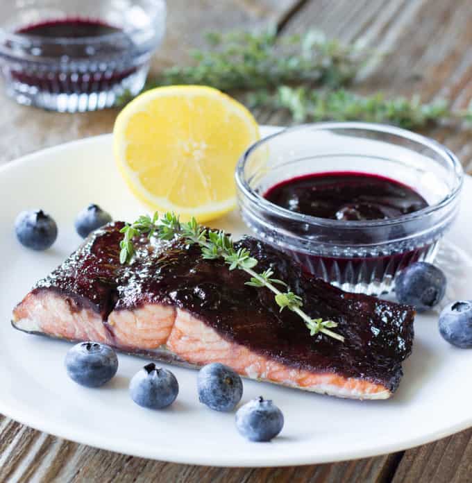 piece of Blueberry Balsamic Glazed Salmon on a white plate