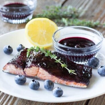 white plate with a piece of Blueberry Balsamic Glazed Salmon