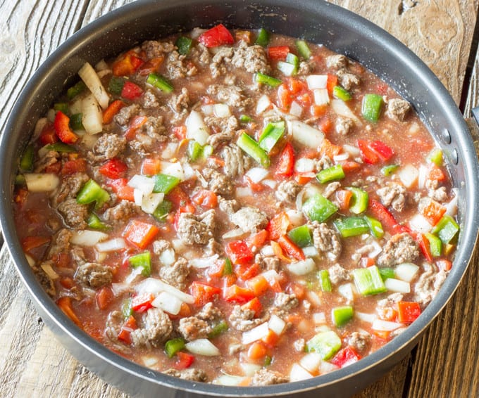 skillet full of uncooked One Pot Stuffed Pepper Skillet