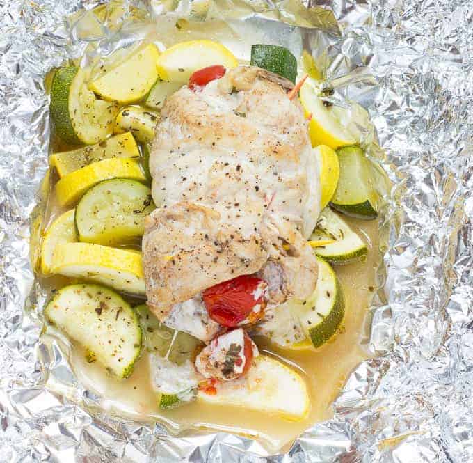 Caprese Stuffed Chicken and sliced squash on foil