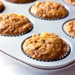 muffin tin full of carrot cake muffins