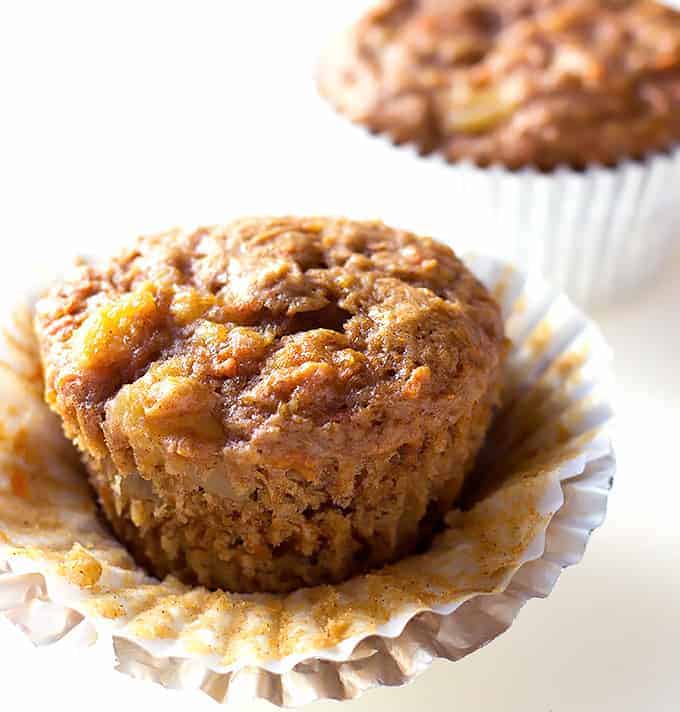 Carrot Cake Muffins on a white plate with the wrapper coming off