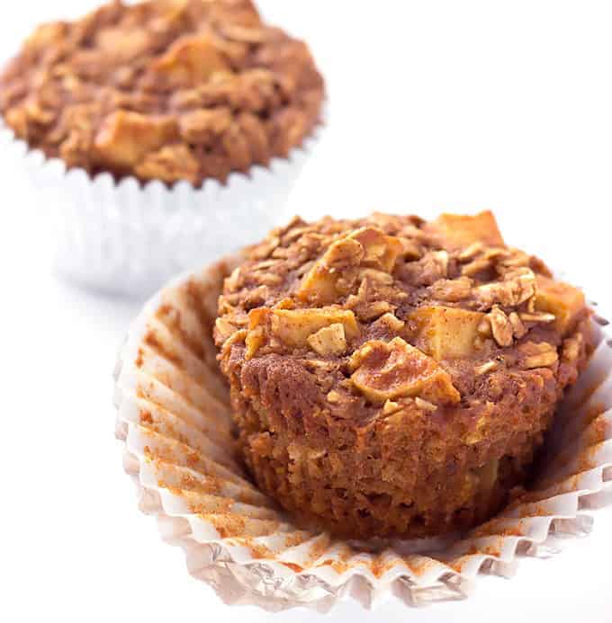 2 Apple Cinnamon Baked Oatmeal Muffins with the wrapper coming off