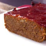 The best traditional meatloaf with ketchup glaze topping sliced on a plate