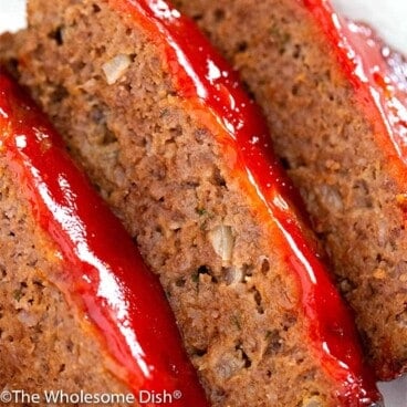 Three slices of meatloaf with ketchup glaze on top.