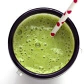 Tropical Green Smoothie in a cup with a straw