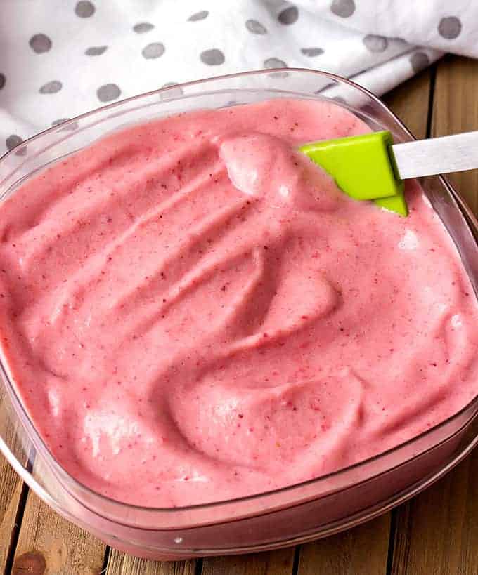 clear container full of strawberry banana frozen yogurt