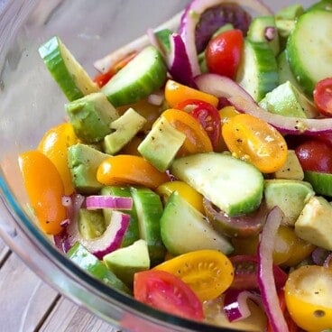 bowl of avocado tomato cucumber salad with balsamic dressing