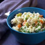 bowl of creamy chicken and rice with veggies and parmesan