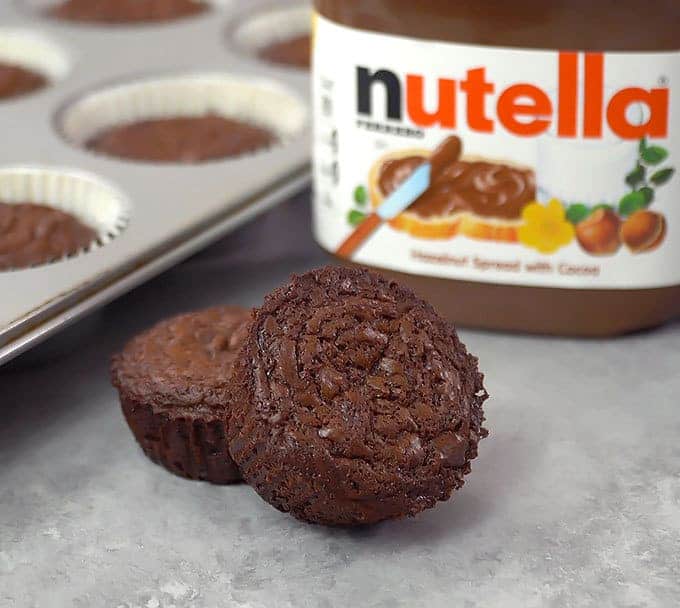 2  Nutella Brownies with a jar of nutella in the background
