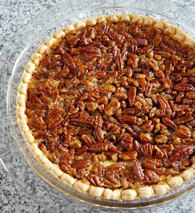 whole Cheesecake Stuffed Pecan Pie in a pie plate