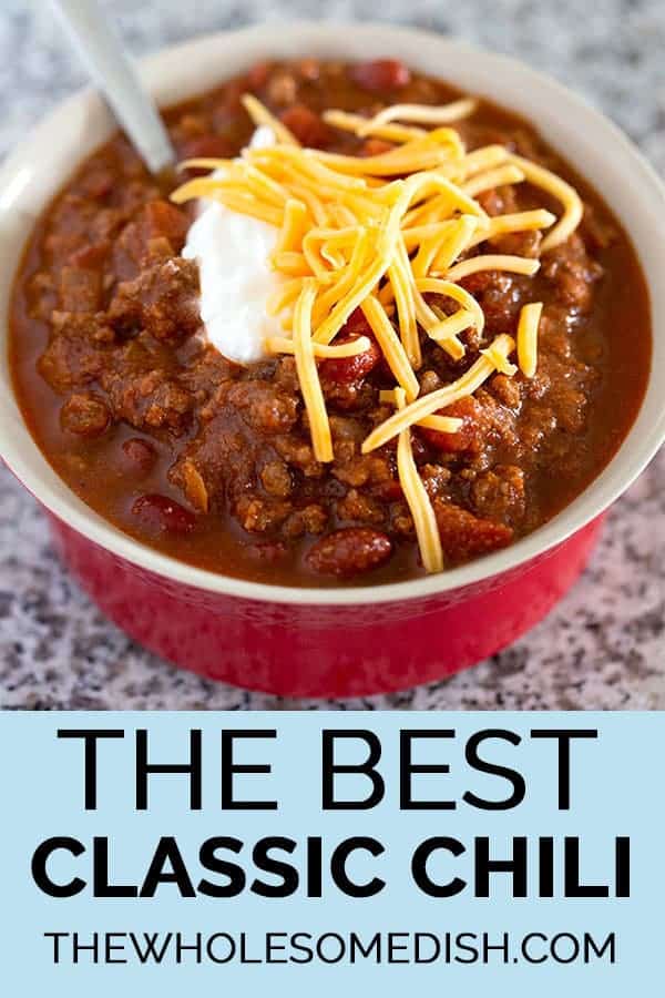 The Best Classic Chili recipe in a red bowl topped with cheese and sour cream