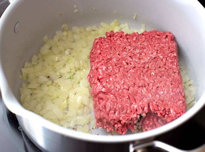 onions and ground beef sautéing in a soup pot