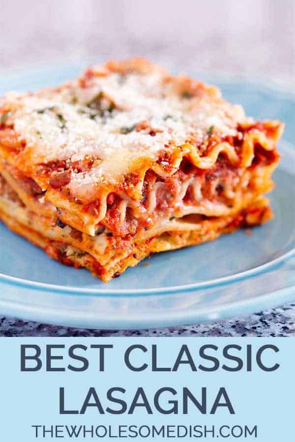 The best classic lasagna, sliced on a blue plate with cheese on top