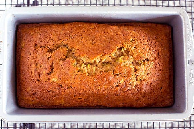 Loaf pan of baked homemade zucchini bread with applesauce