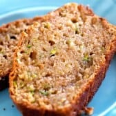 two slices of the best zucchini bread recipe on a blue plate