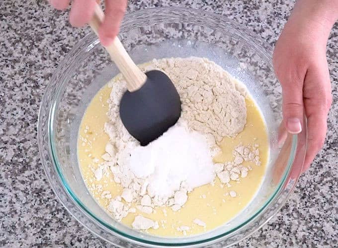 A mixing bowl with the dry ingredients on top of the wet ingredients for the best pancake recipe