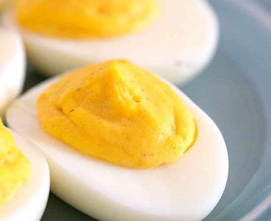 Deviled eggs on a blue plate from the best deviled egg recipe